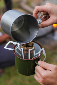 Midsection of person holding coffee cup