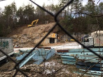 Abandoned building seen through chainlink fence