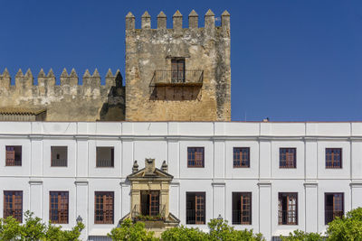 Low angle view of historic building against clear blue sky