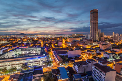 Illuminated cityscape against sky at night