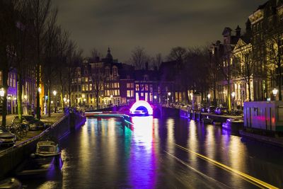 View of canal in city at night