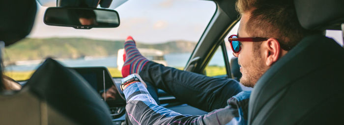 Rear view of man sitting in car