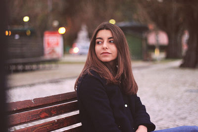 Portrait of young woman in city