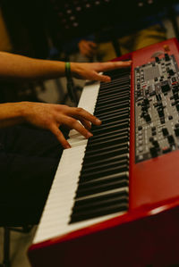 Cropped hands playing piano