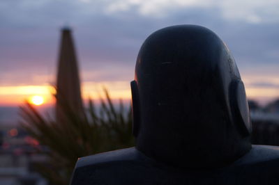 Close-up of statue against sky during sunset