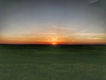 Scenic view of field against sky during sunset