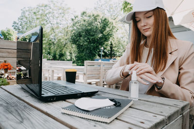 Working safely in new normal. how to make a covid secure workplace. redhead business woman 