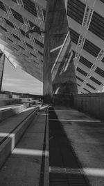 Low angle view of bridge against buildings in city