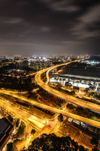 High angle view of illuminated cityscape against sky at night