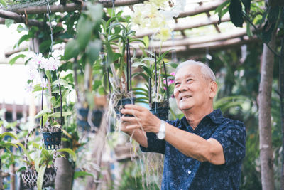 Young woman looking at flowering plants