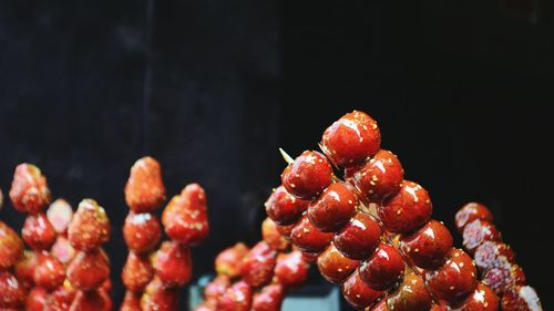 Close-up of cherries over black background