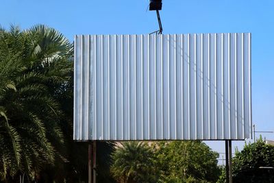 Low angle view of palm trees against clear sky