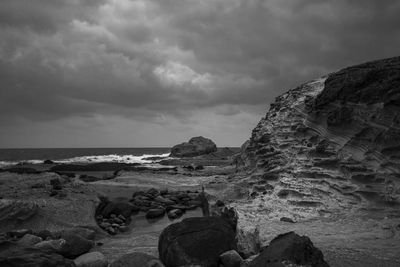 Rocks on beach against sky