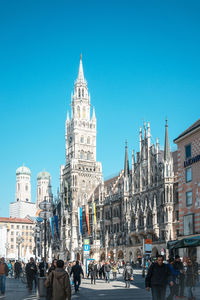 Low angle view of new town hall against clear blue sky