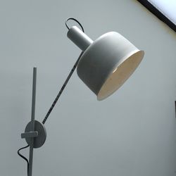 Close-up of electric lamp hanging against white wall