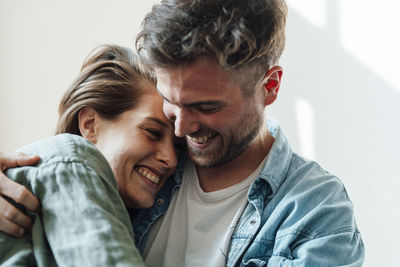 Man embracing woman at home