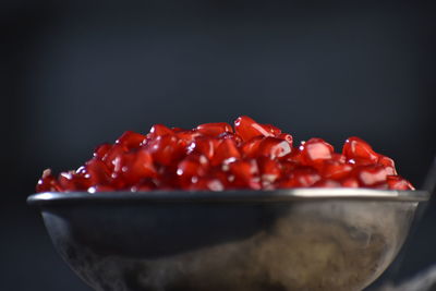 Close-up of strawberries in bowl against black background