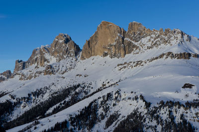 Scenic view of snowcapped mountains against clear blue sky