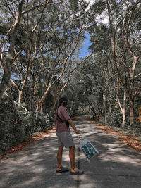 Side view of woman walking on road