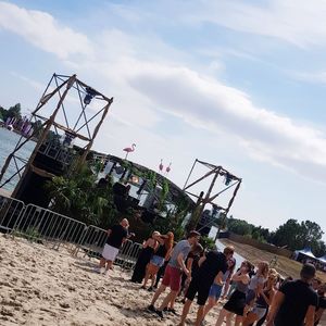 People playing on beach against sky