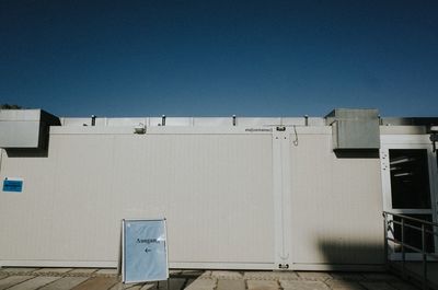 Low angle view of building against clear blue sky