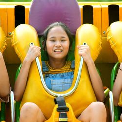 Portrait of smiling girl sitting outdoors