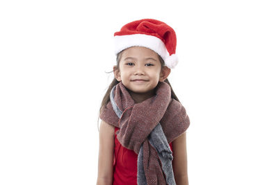 Portrait of cute girl wearing hat against white background