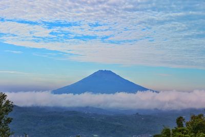 View of volcanic landscape against cloudy sky