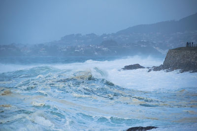 Great waves of the atlantic ocean splashing and foaming on the coast of baiona, spain