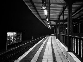 Empty railroad station platform at night