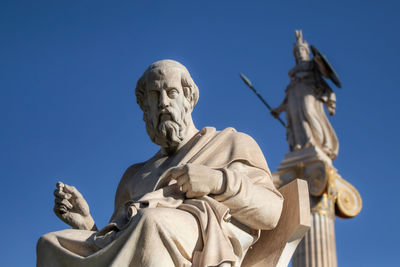 Low angle view of statue against clear blue sky