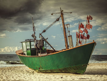 Fisherman's boat docked at the sandy wharf - miedzyzdroje beach, poland