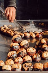 Close-up of person preparing food in cooking oil
