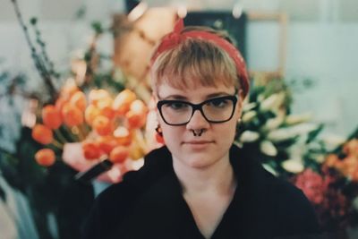 Portrait of young woman wearing eye glasses and nose ring