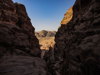 Low angle view of rocky mountains against clear sky