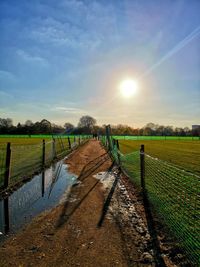 Fence on field against sky