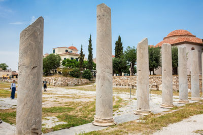 Tourists visiting the ancient ruins at the roman agora in athens