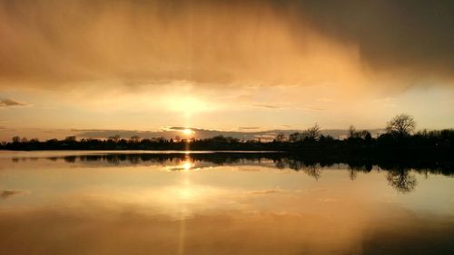 Scenic view of lake at sunset