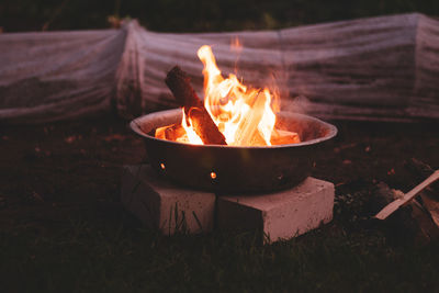 Close-up of bonfire on field at night