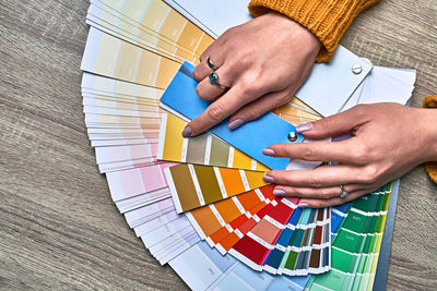 High angle view of woman hand holding paper