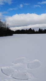 Scenic view of frozen landscape against sky