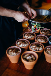 Midsection of man preparing food on table