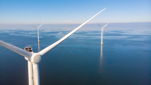 Low angle view of windmill against sky