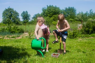 Full length of children on grassy field