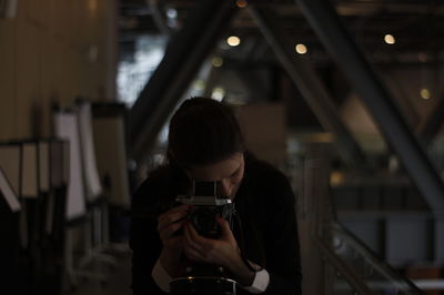 Woman photographing in workshop