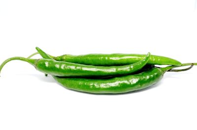 Close-up of green chili pepper against white background