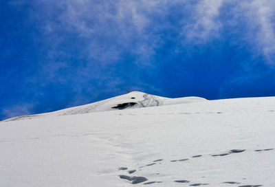 Snow covered landscape against sky