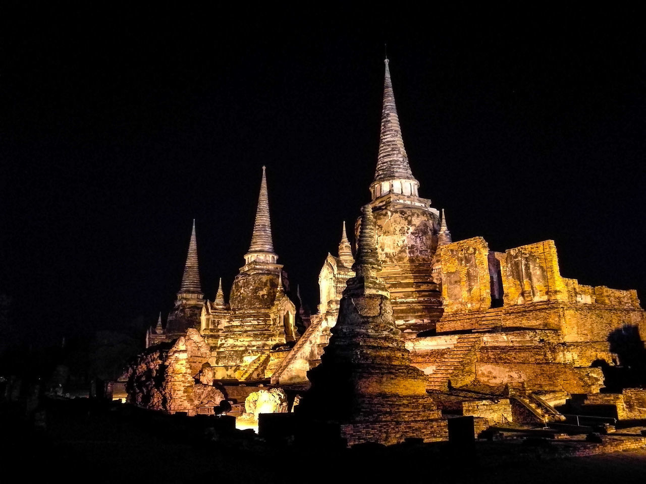 LOW ANGLE VIEW OF ILLUMINATED TEMPLE