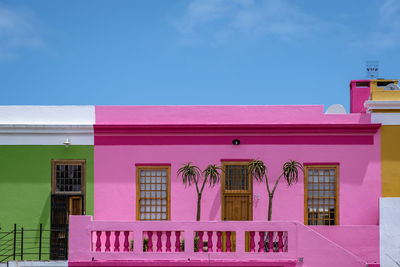 Low angle view of pink building against sky