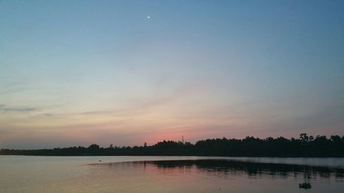 Scenic view of lake at sunset